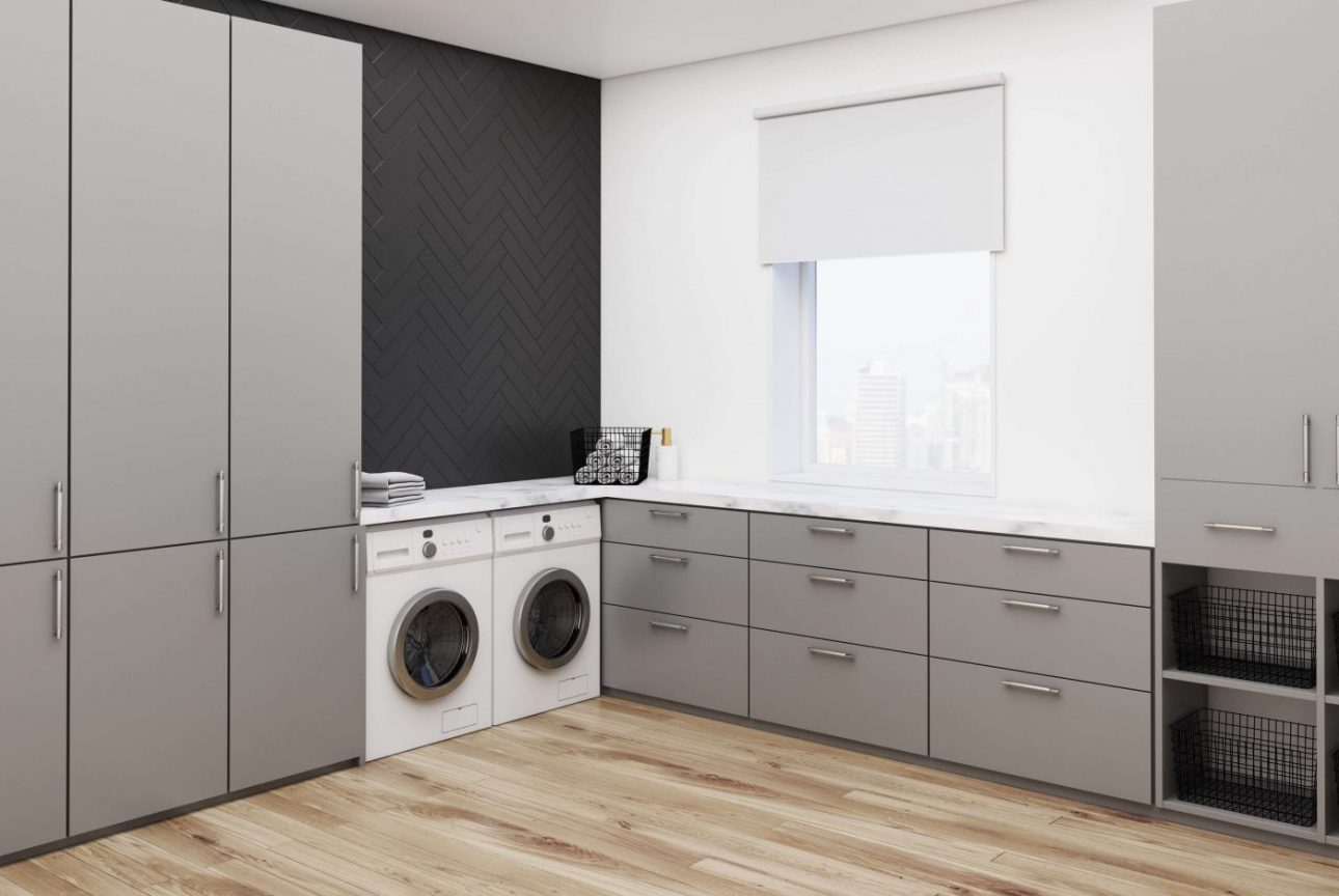A custom dream laundry room that has white and gray colors.
