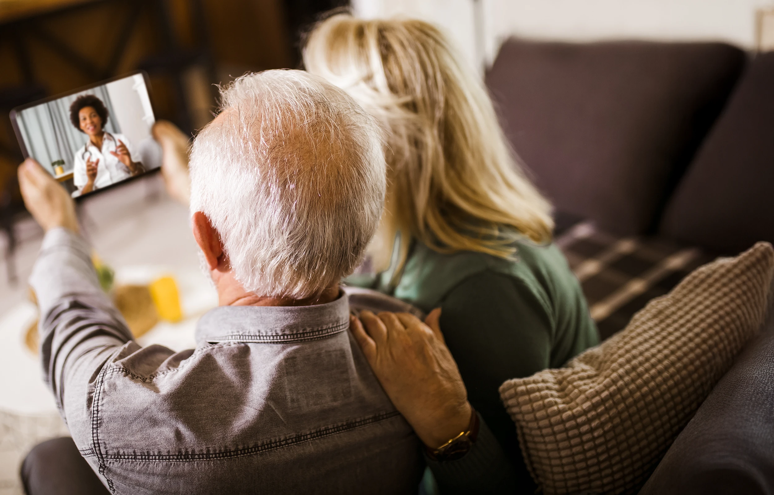 A man and a woman are sitting on a couch.