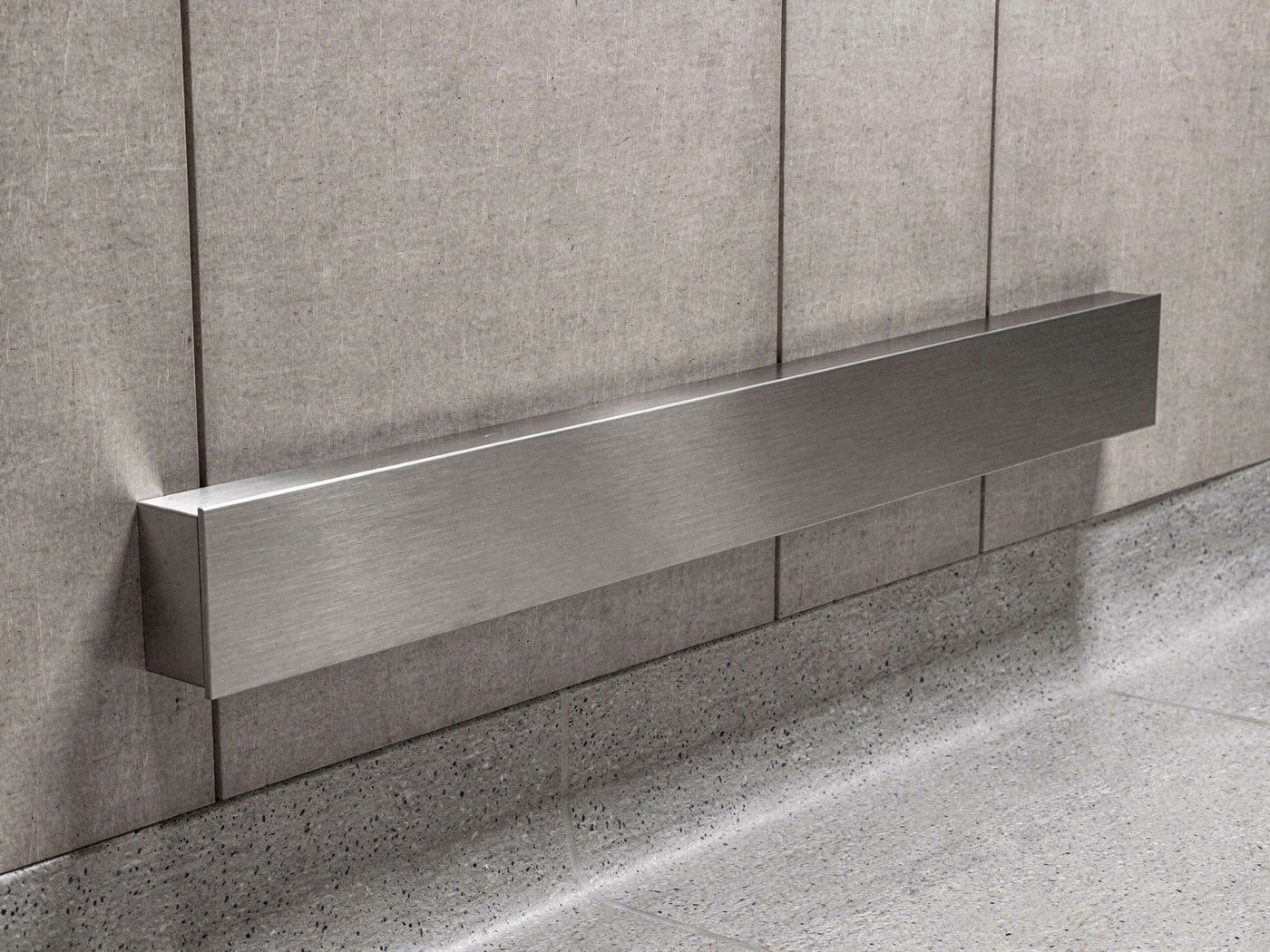 Stainless steel bumper guard mounted low on an elevator cab wall just above the floor