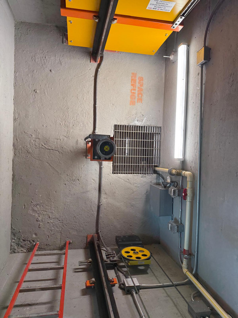 Elevator hoistway with yellow governor and safe refuge space at Mater East Academy in Miami