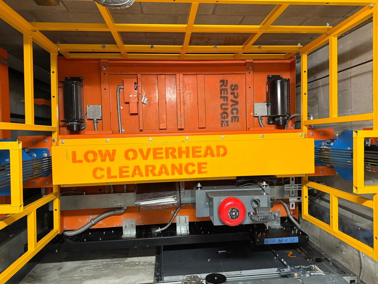 Elevator car top with safety railing, alarm bell and low overhead clearance guard at Mater East Academy in Miami