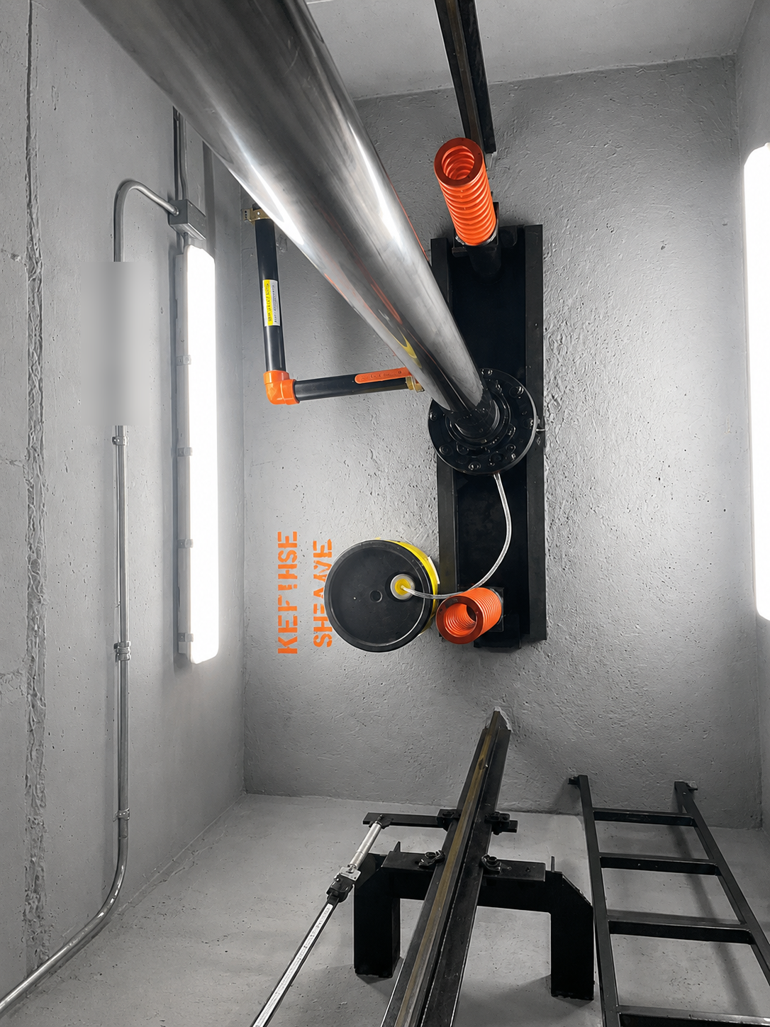 Elevator hoistway with refuge sheave, hydraulic jack and guide rails at 100 Miracle Mile in Coral Gables
