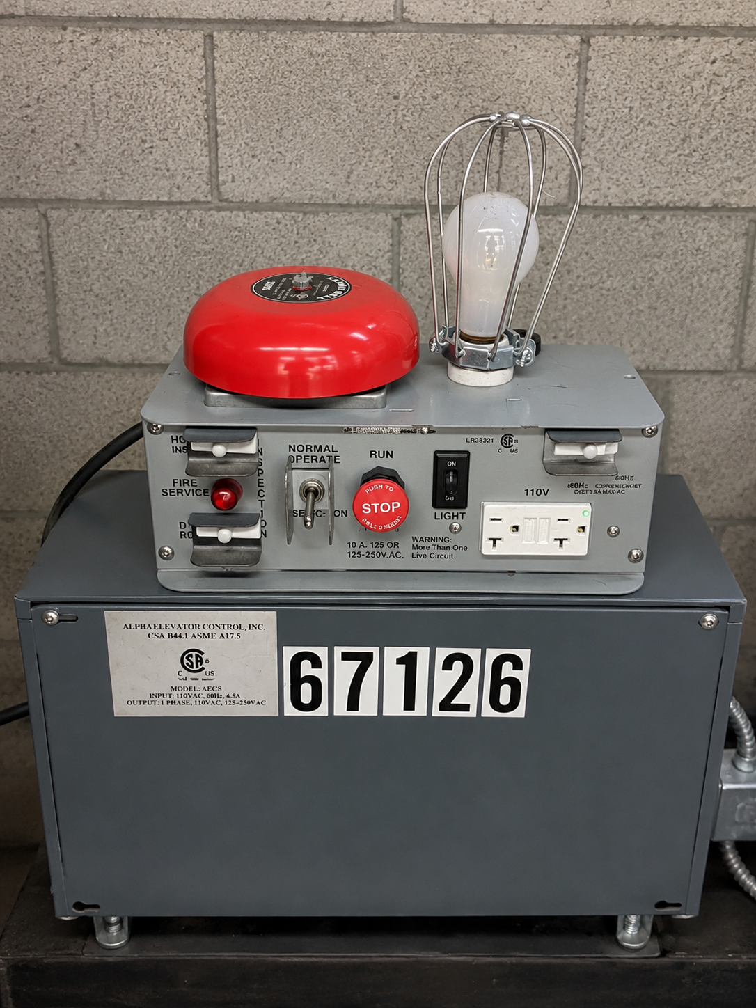 Villa Grande elevator machine room control station with fire service selector switches and state inspection ID plate