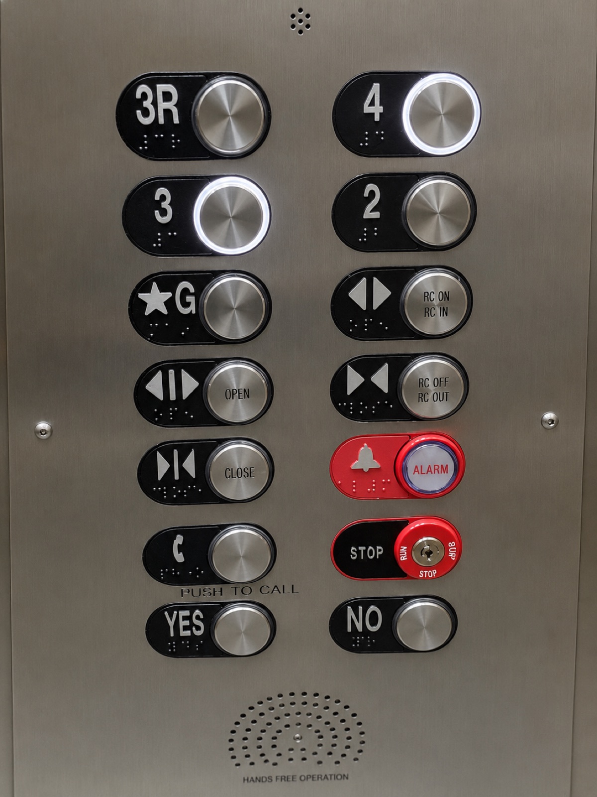 Elevator car operating panel with braille floor buttons, hands free call and alarm at 100 Miracle Mile in Coral Gables