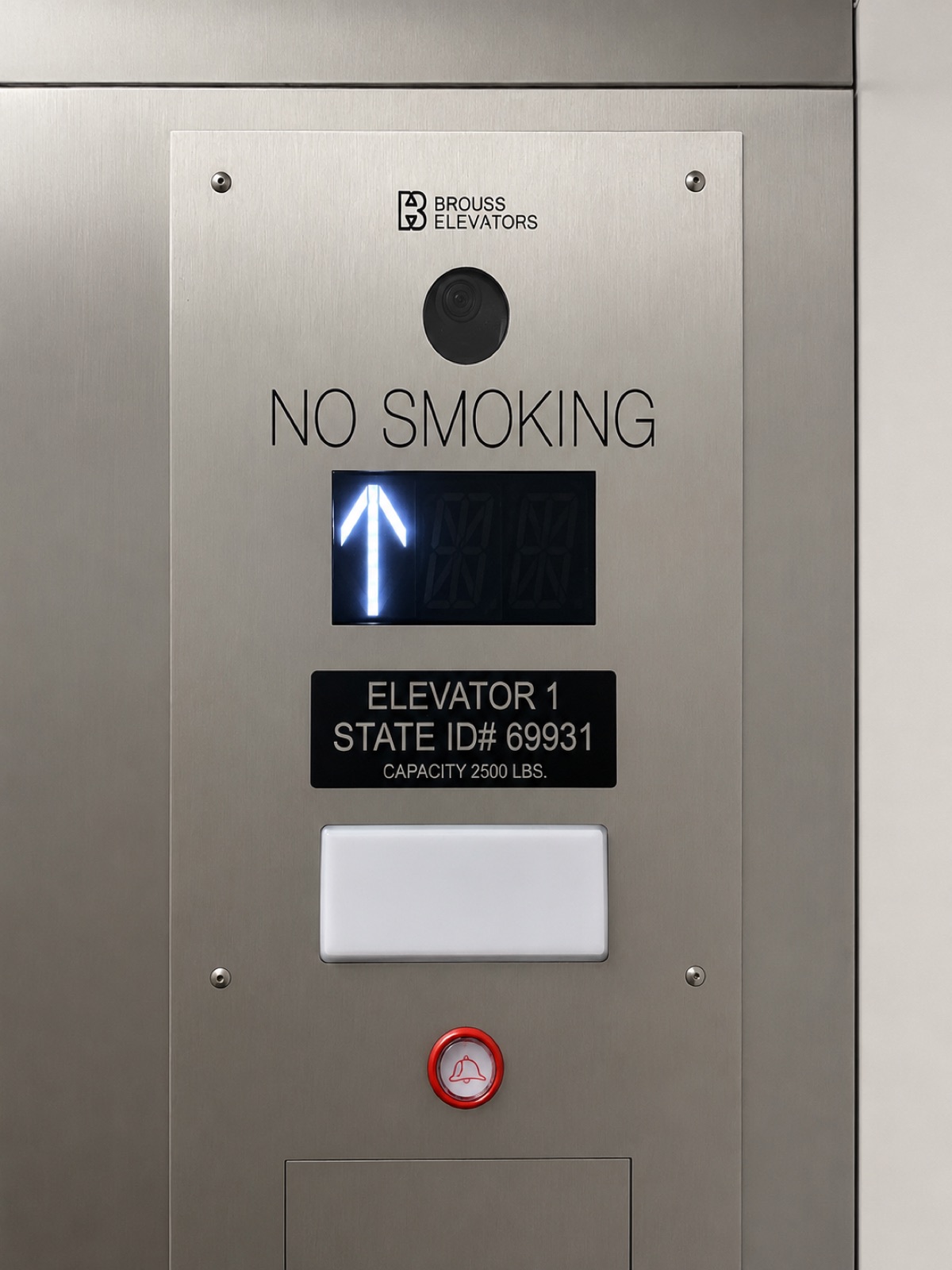 Elevator car operating panel with the state ID plate and Brouss branding at Lakeside Commons