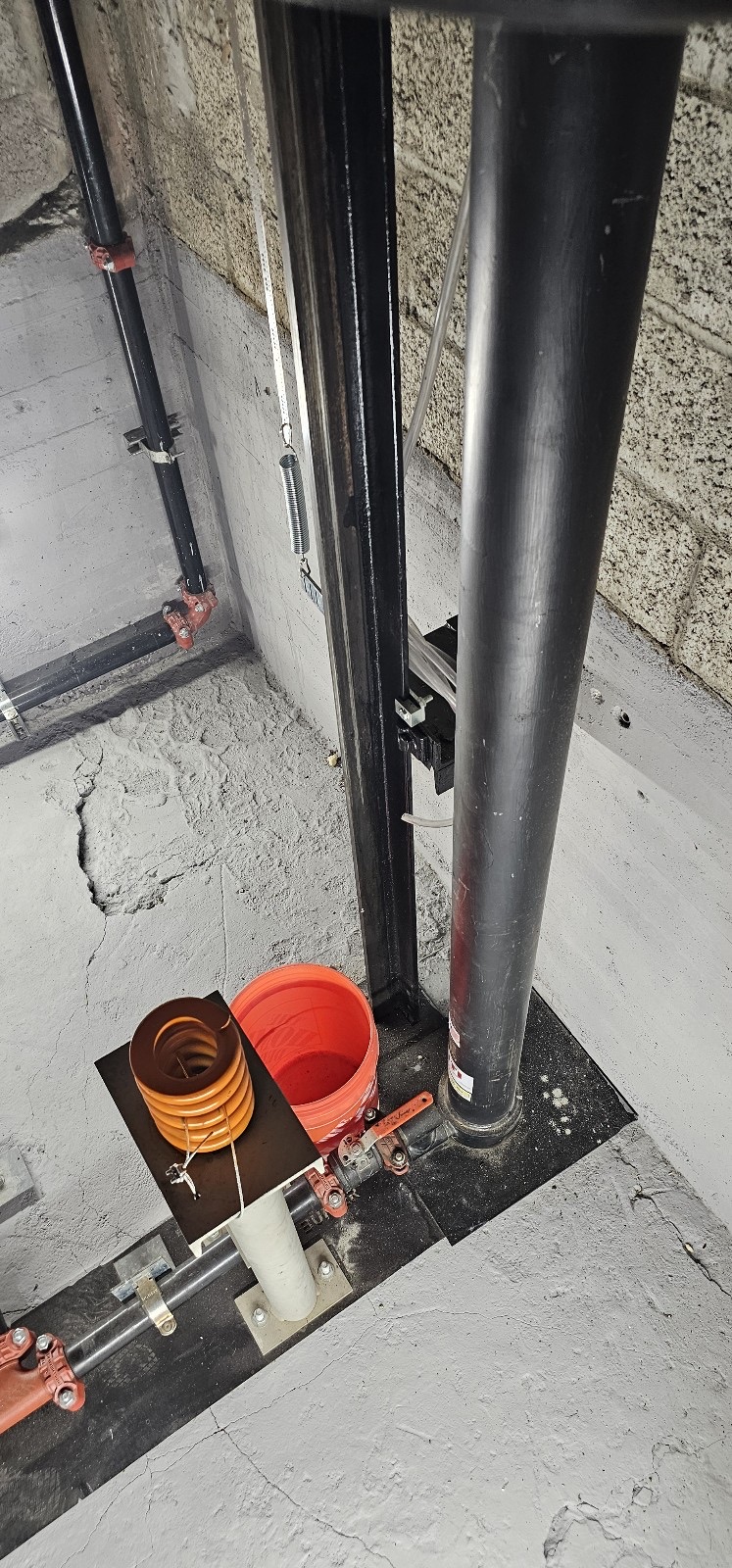 Holeless hydraulic elevator jack and buffer in the pit at 2115 Hollywood Building