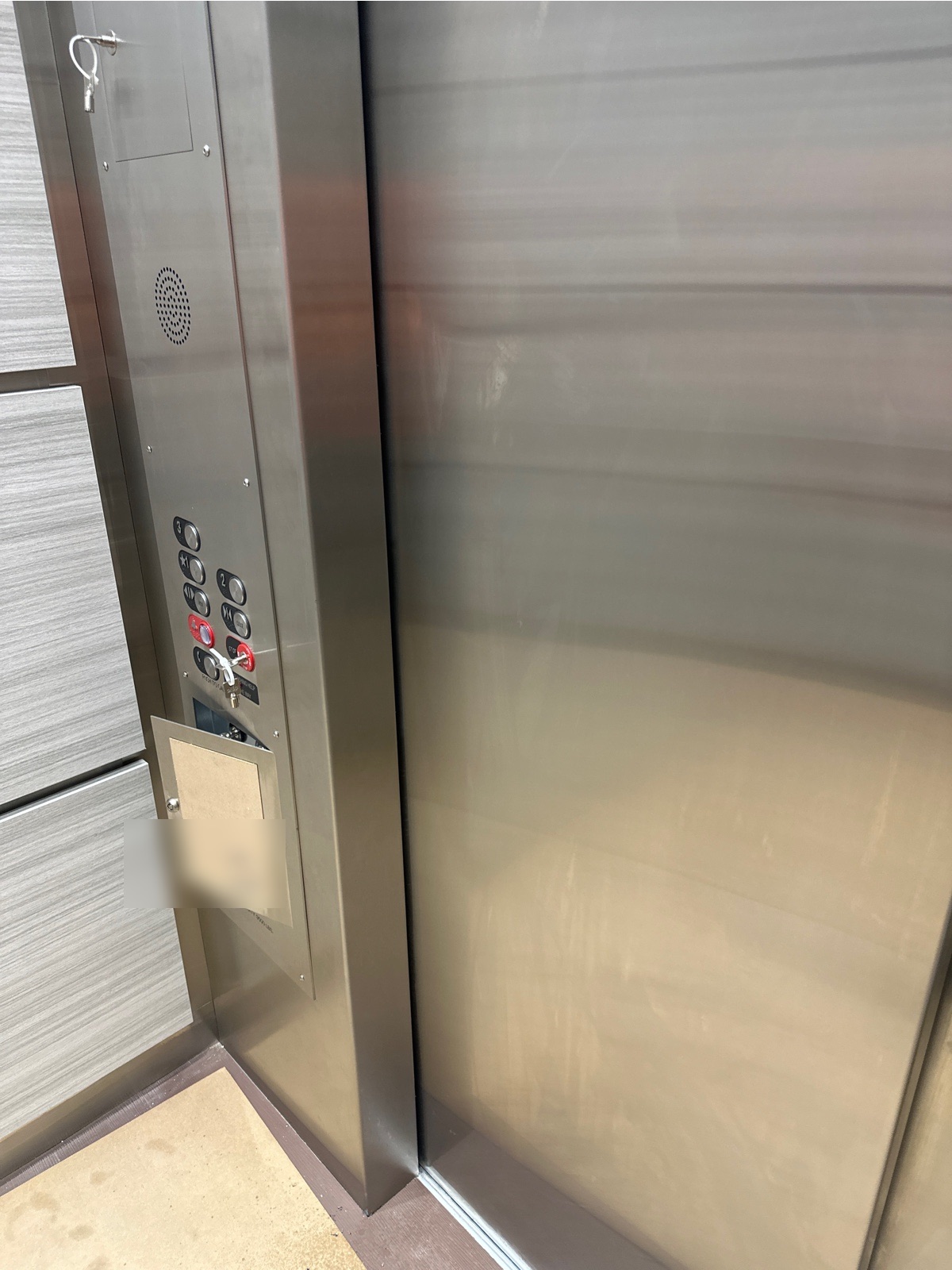 Elevator cab interior with stainless and laminate walls and the car operating panel at 2115 Hollywood Building