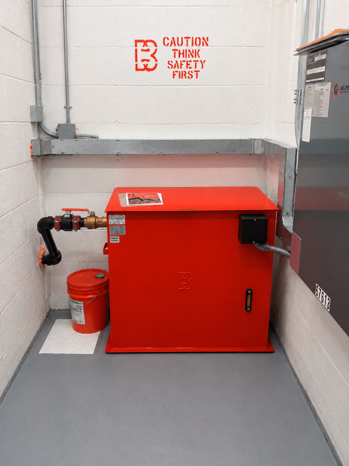 New red Brouss hydraulic power unit in the machine room at Girosol Corporation Office