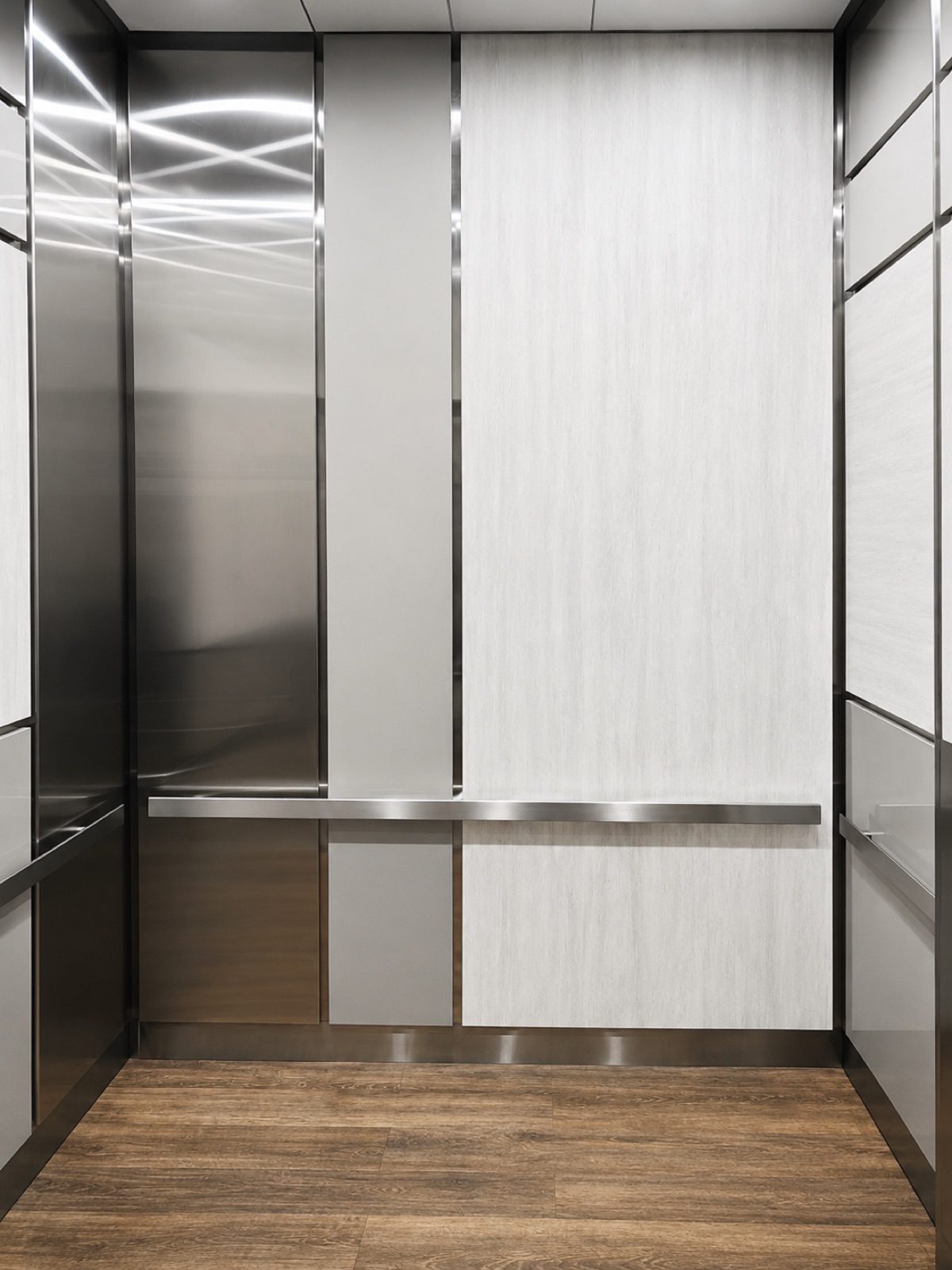 Modernized elevator cabin interior with stainless steel and wood-look panels at the School Board Administration Building