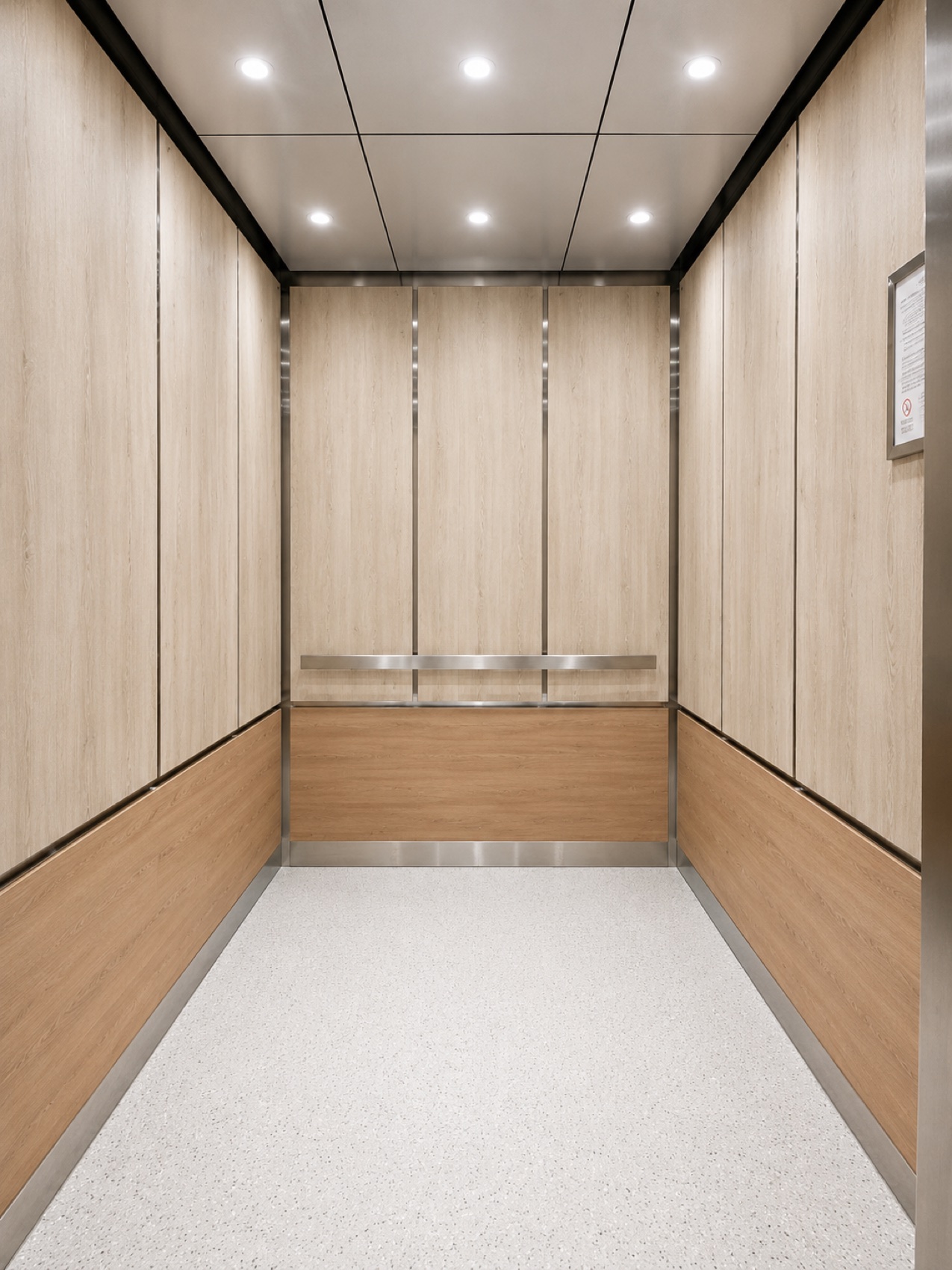 Modernized elevator cab interior with light wood panels and stainless steel handrail at Ward Law Office Building