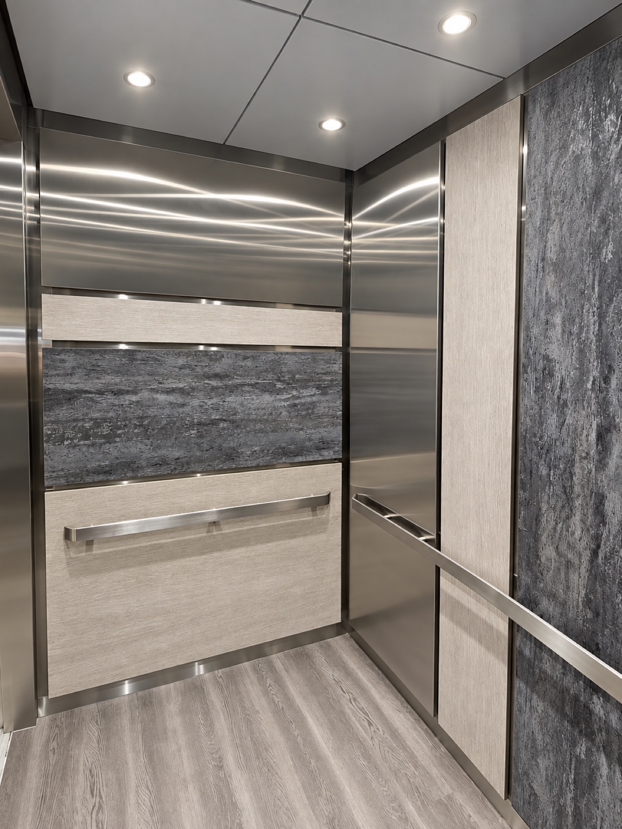 Modernized elevator cab interior with wood grain and stone panels framed in brushed stainless steel