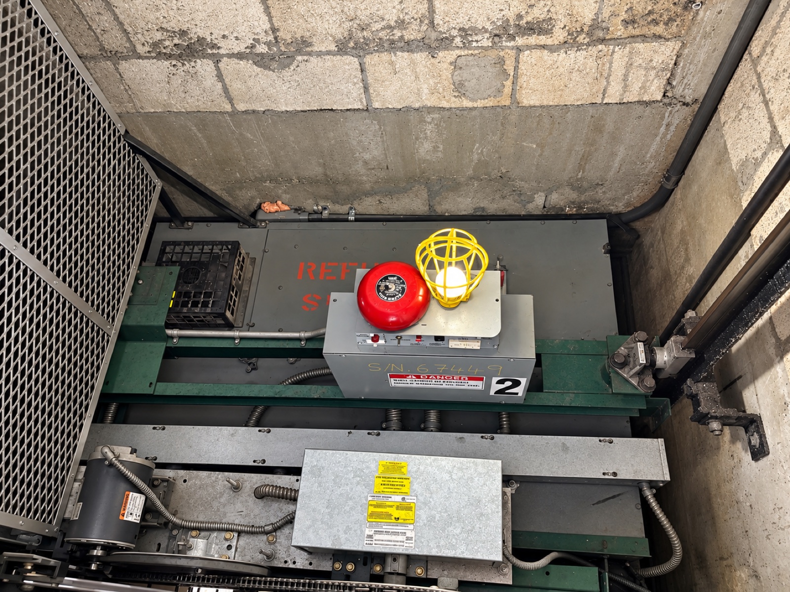 Car top equipment at 1140 Towers in Hialeah, with the alarm bell, caged emergency light and door operator