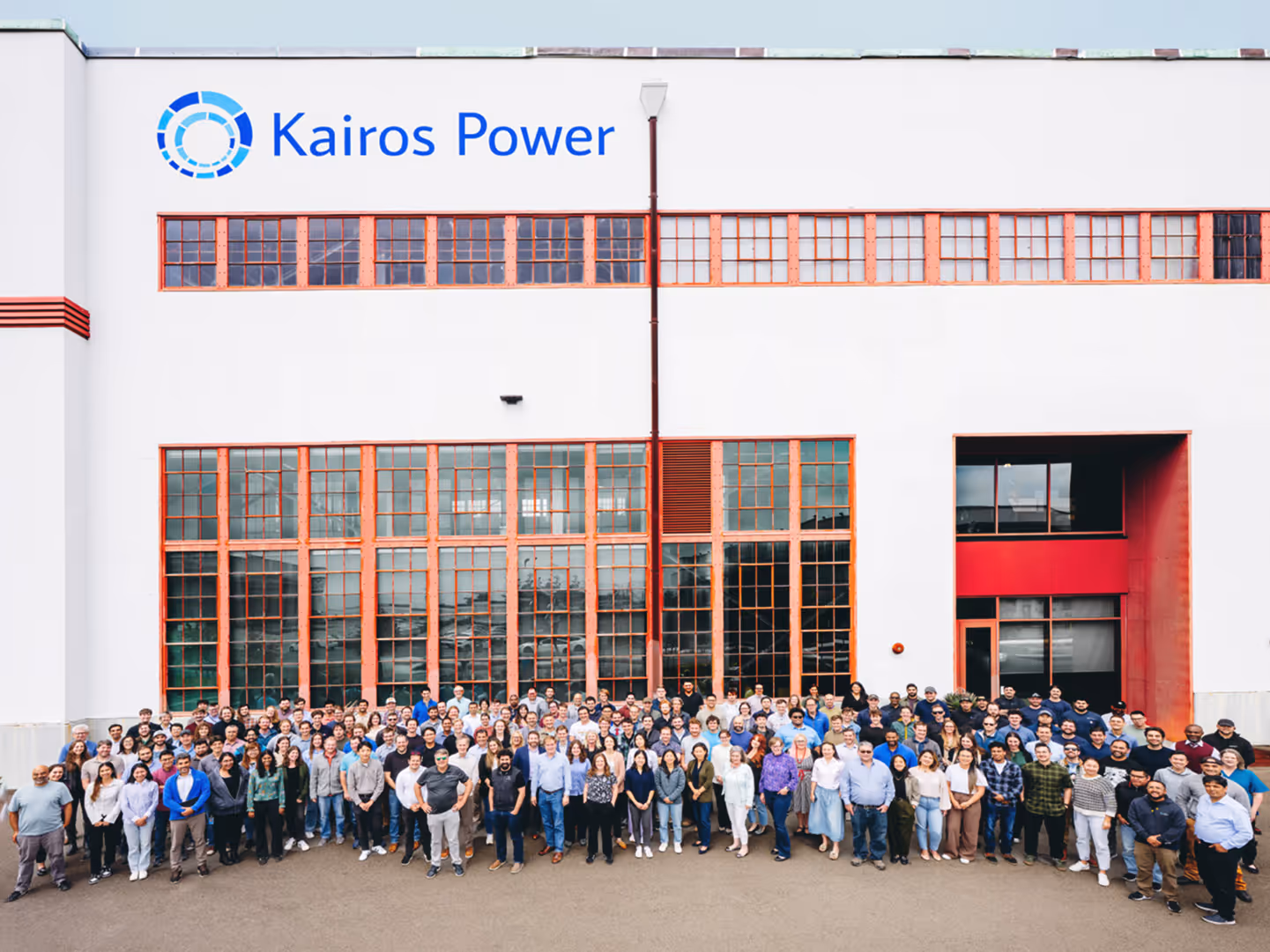 Larger team photo inside facility