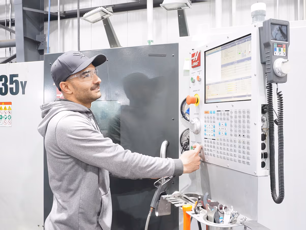 Worker making adjustments on control paenl