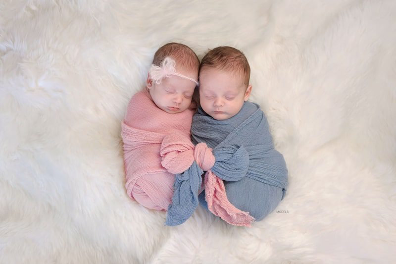 A pair of newborn fraternal twins - boy and girl.