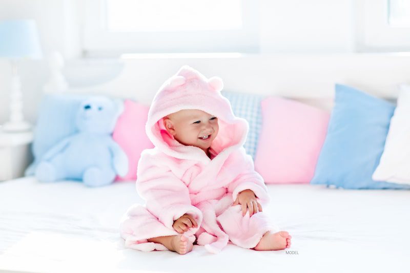 Baby girl in a pink bathrobe.