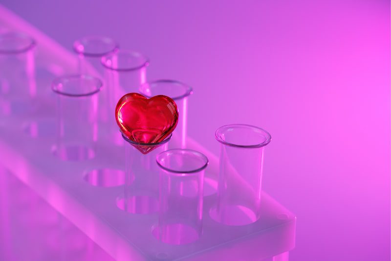 Red heart sitting on top of a test tube.