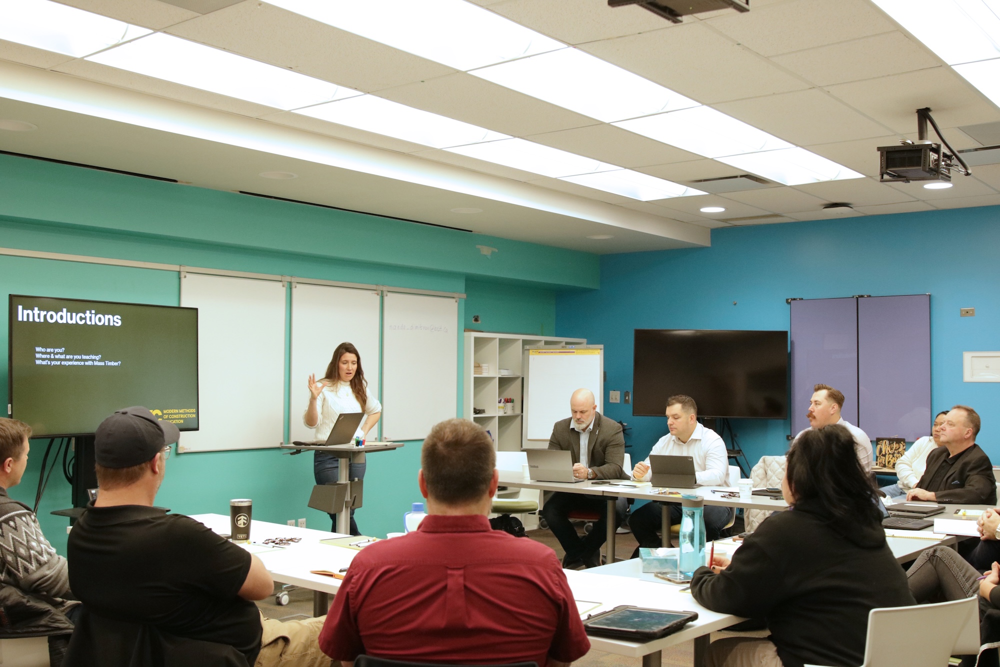 Network members seated around a table discussing education.