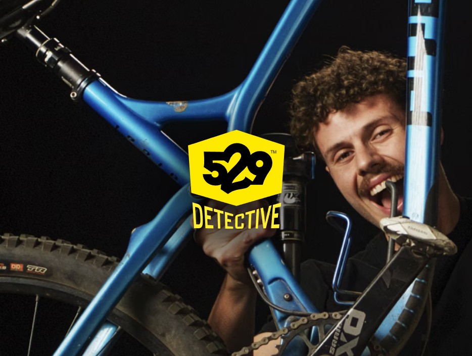 man holding up a stolen bicycle that he has been reunited with