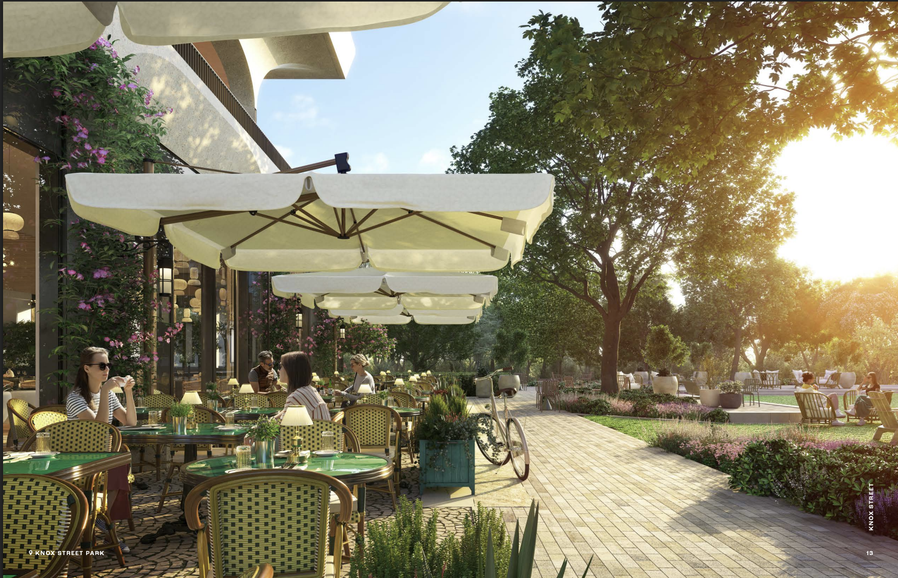 Sunset view of a modern urban park surrounded by office buildings with people socializing on the lawn and terraces.