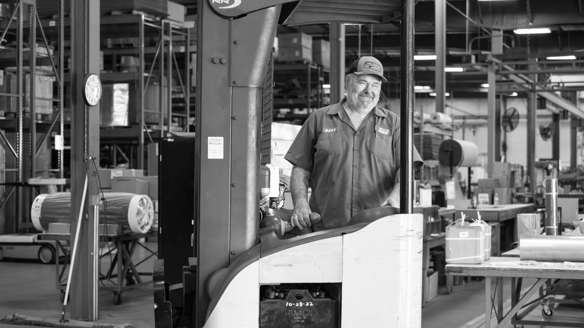 Man operating forklift in warehouse.