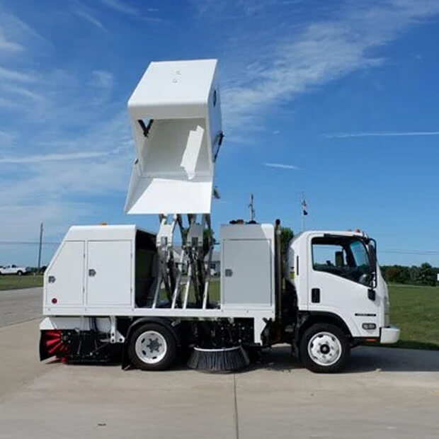 Stewart-Amos street sweeper with raised hopper.