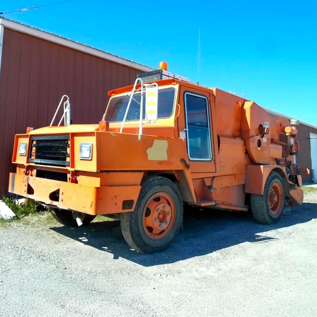 Mobil M8A orange street sweeper.