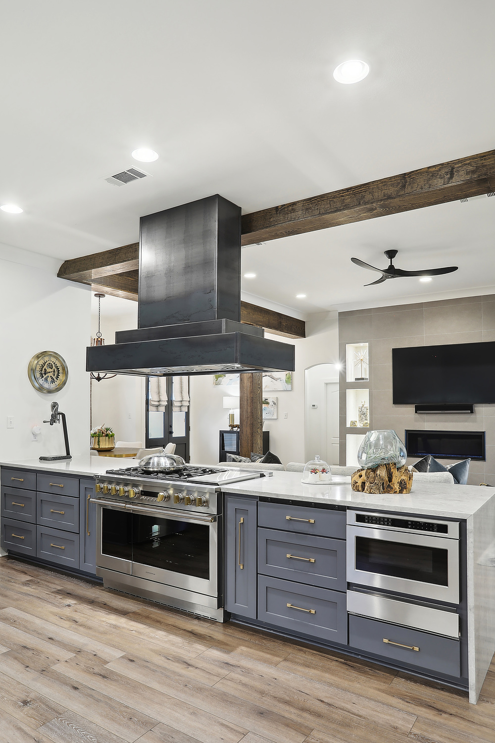 large kitchen island with metal range hood |