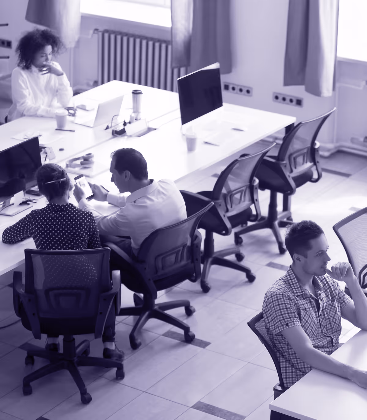 Team of professionals working at desks in an open office.