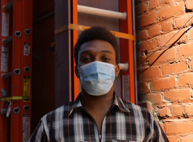 Photo of intern peter deyi with mask on