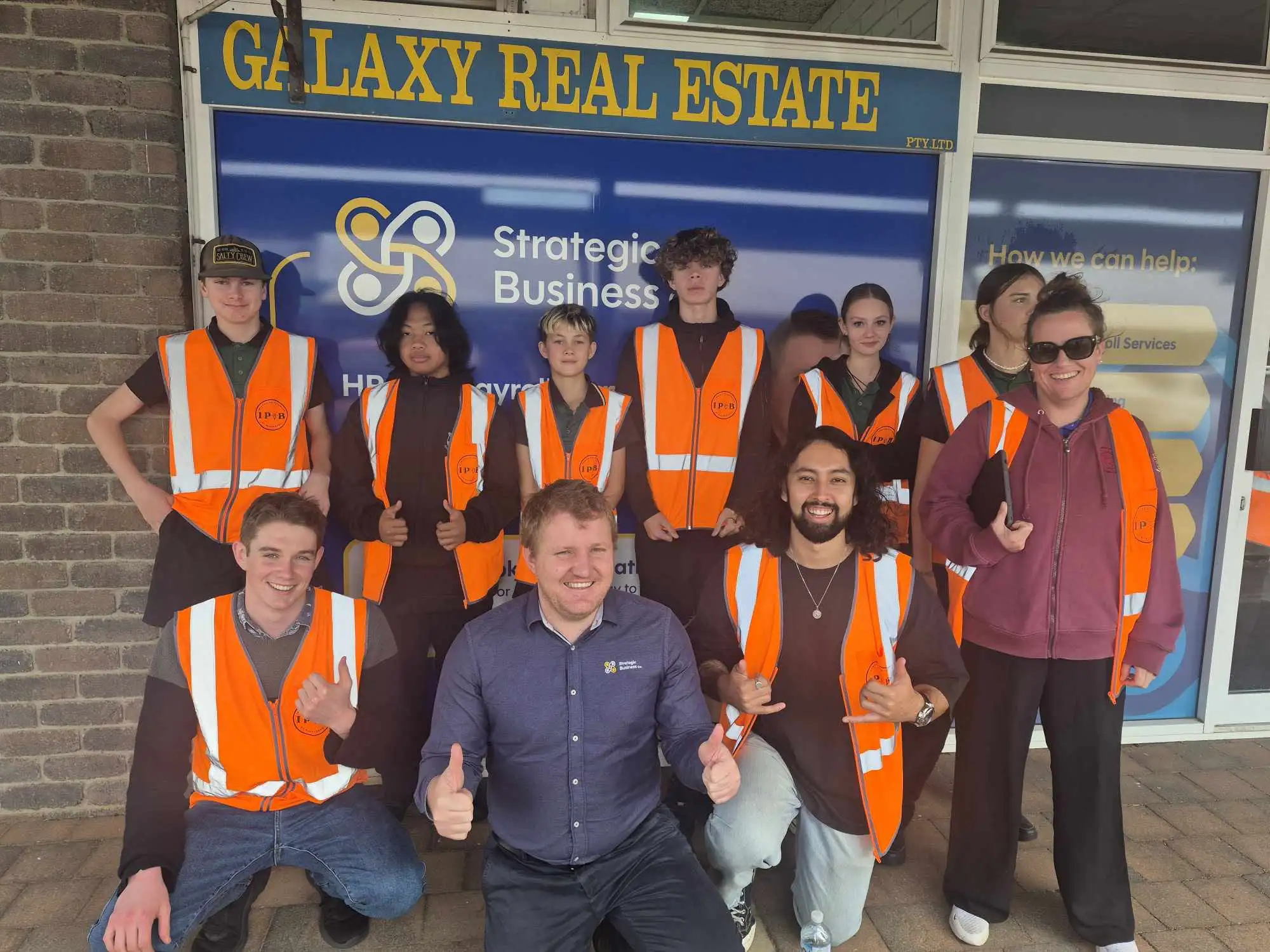 Human Resources Partner, Nathan Atkinson in a group photo with students in high-vis vests for the IP@B Program