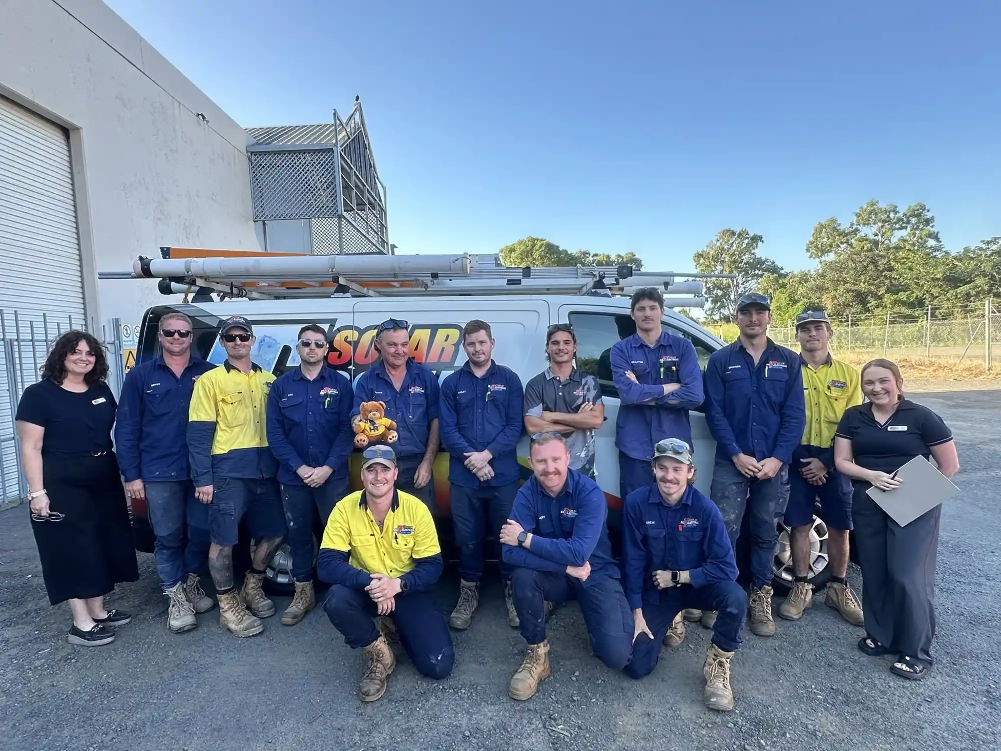 Team group photo of Big T Electrical team in front of a work van with their branding, along with team members from Strategic Business Co