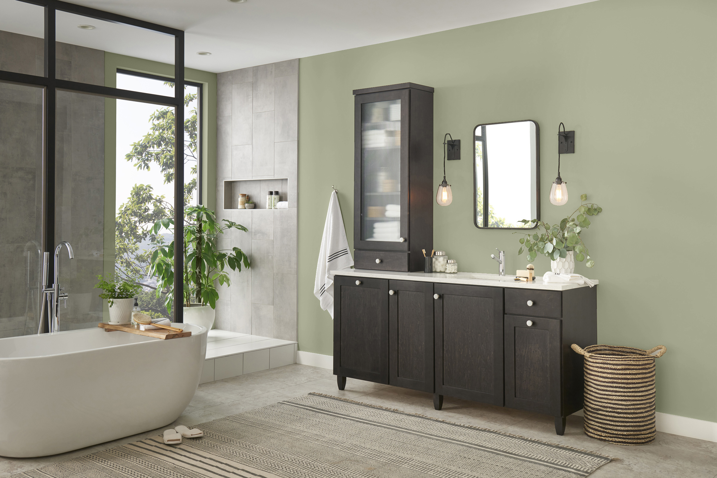 Contemporary bathroom with light olive green walls and a dark wood vanity