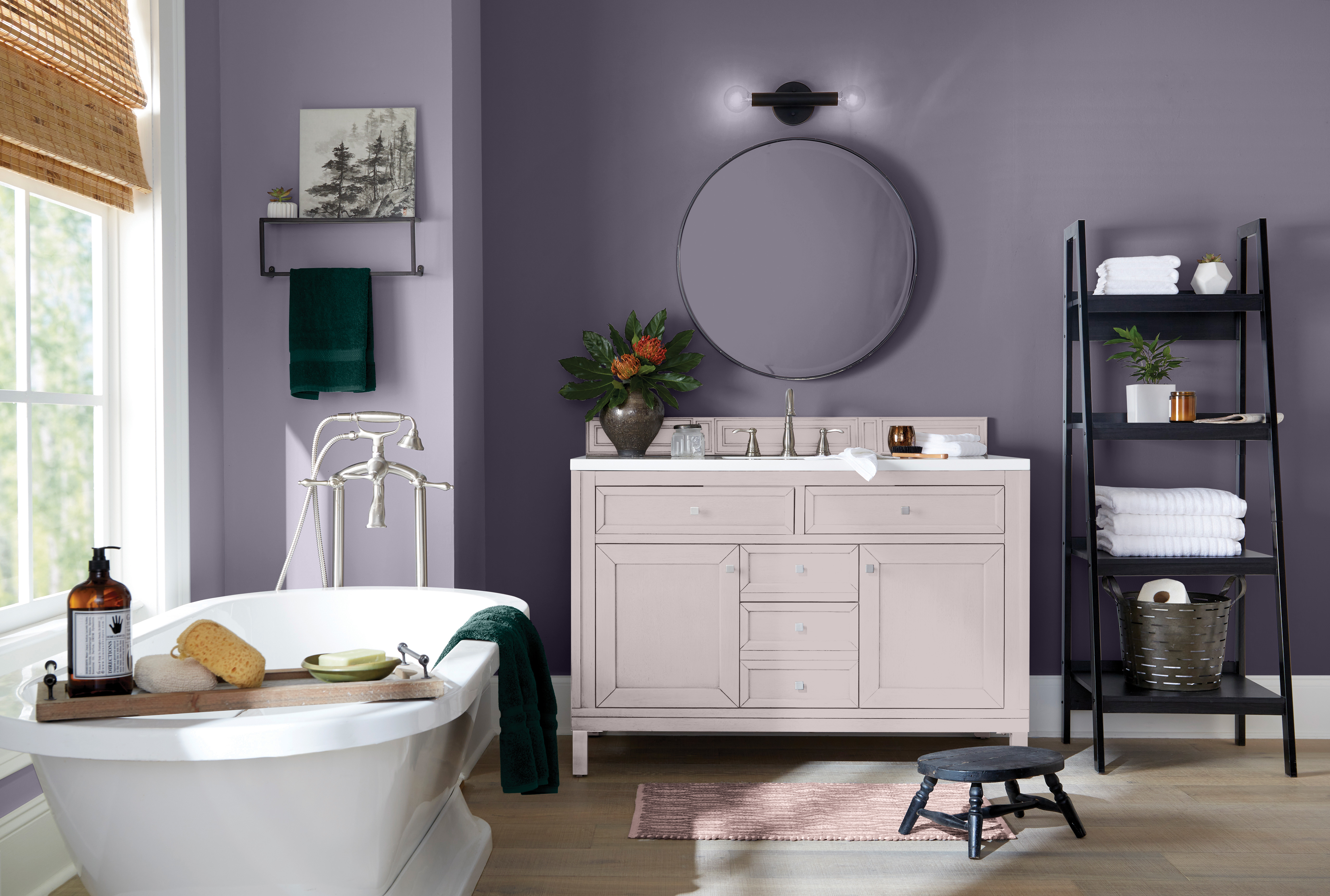 Cozy bathroom featuring a light wood vanity and soft purple-grey walls