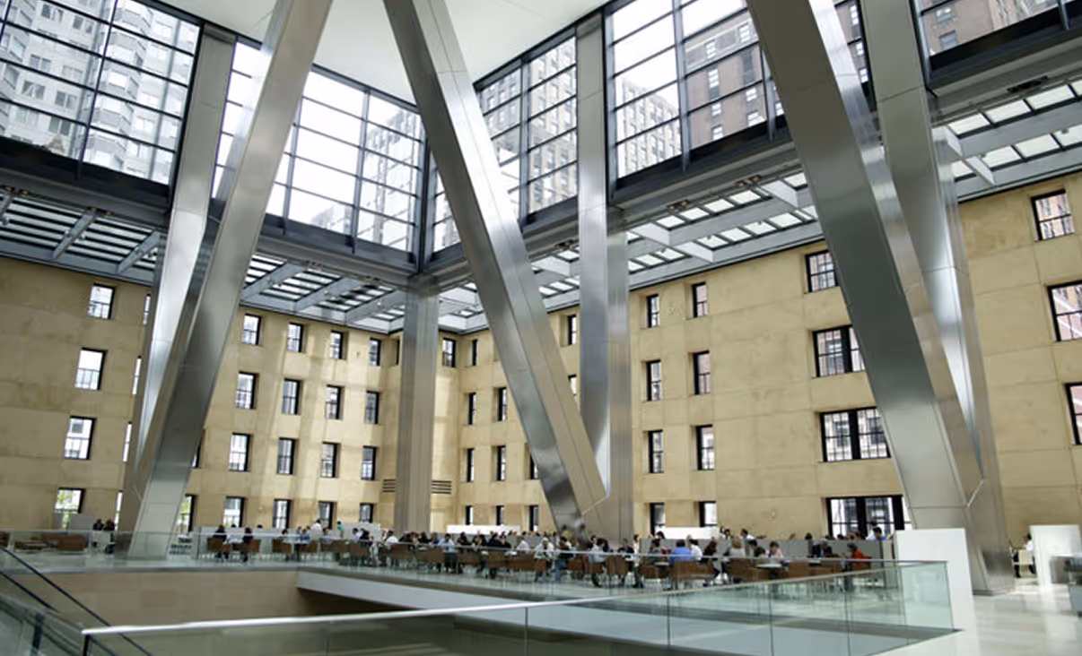 Interior of the Hearst Tower atrium in New York City, showing the open lobby space and structural steel supports.