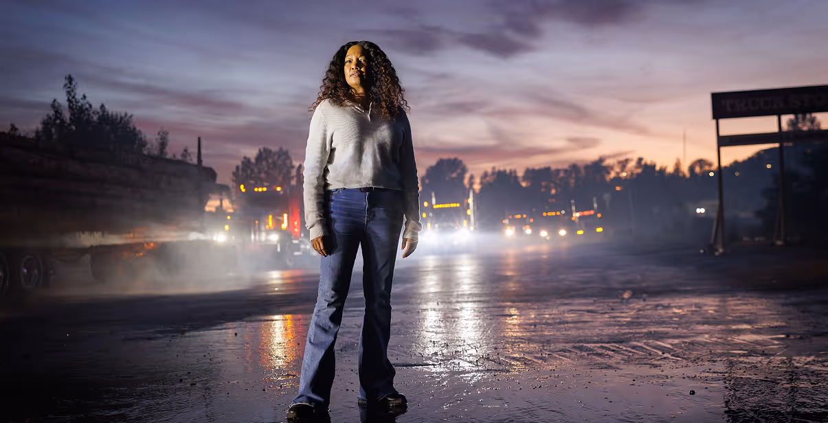 Garcelle Beauvais standing on a road at dusk in a dramatic scene from Black Girl Missing.