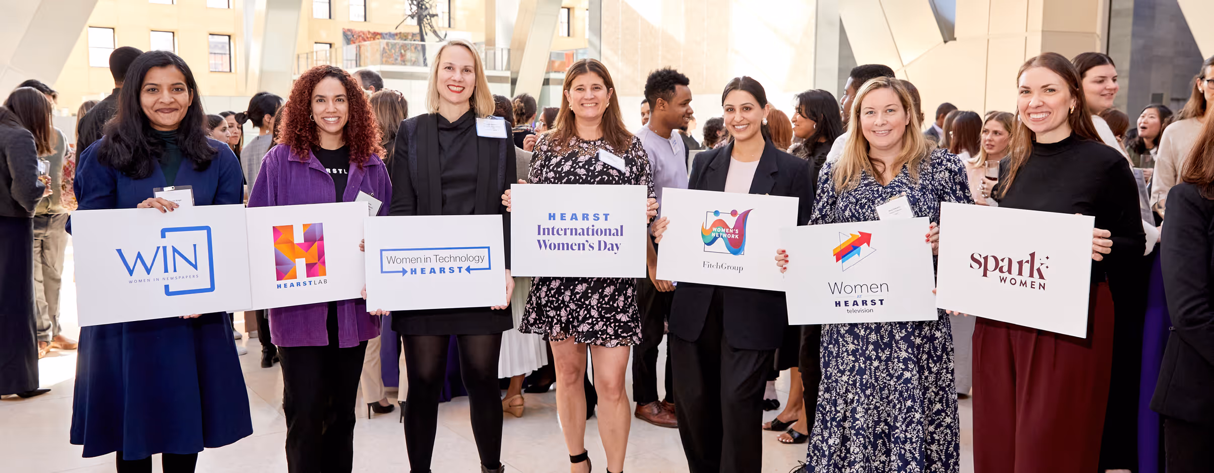 Hearst employees representing women-focused ERGs, including Women in Technology and Women in Hearst Television, at an International Women’s Day gathering.