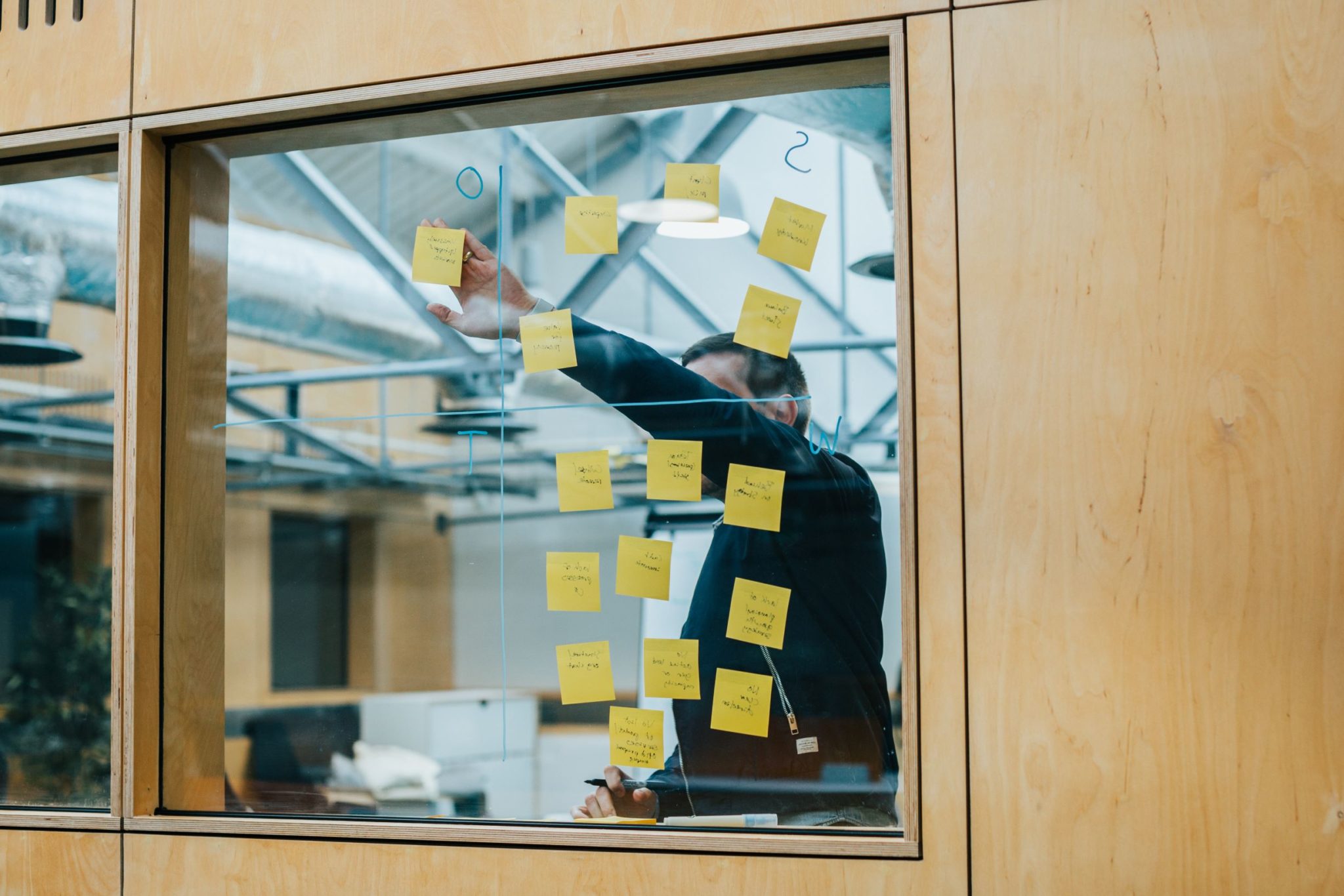 A person developing ideas with sticky notes in a shared workspace at Carriage Works, Swindon