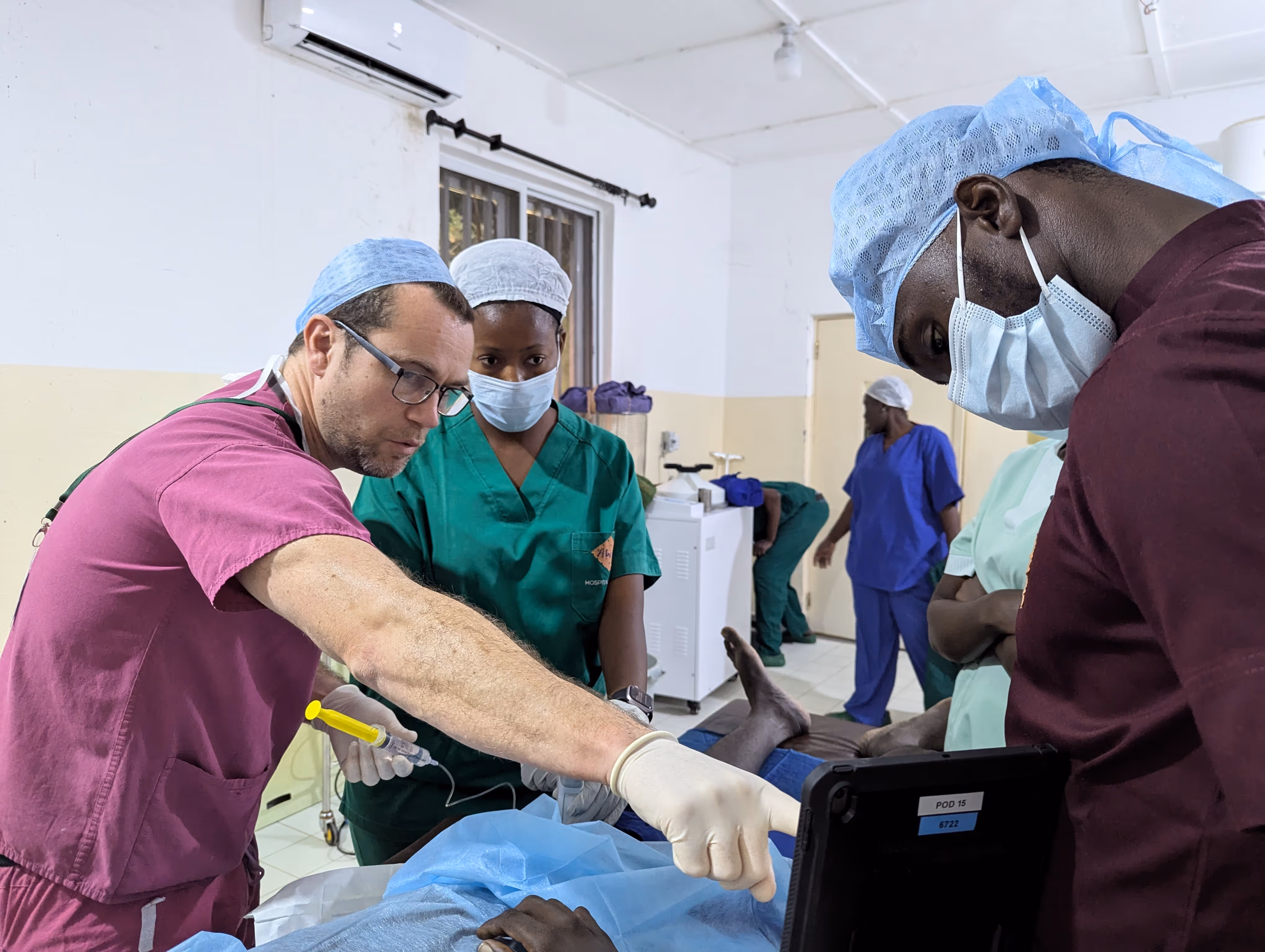 Doctors and nurses focused on performing surgery in a hospital operating room.