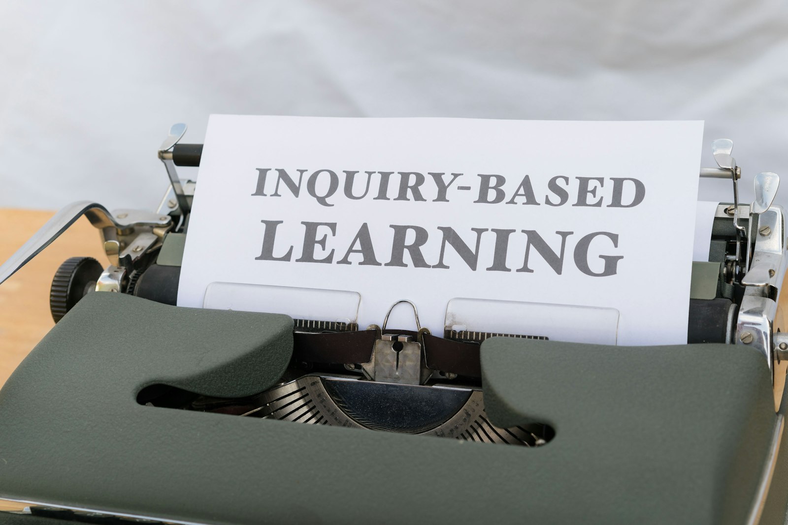 Typewriter with 'inquiry-based learning' to represent education and learning. 