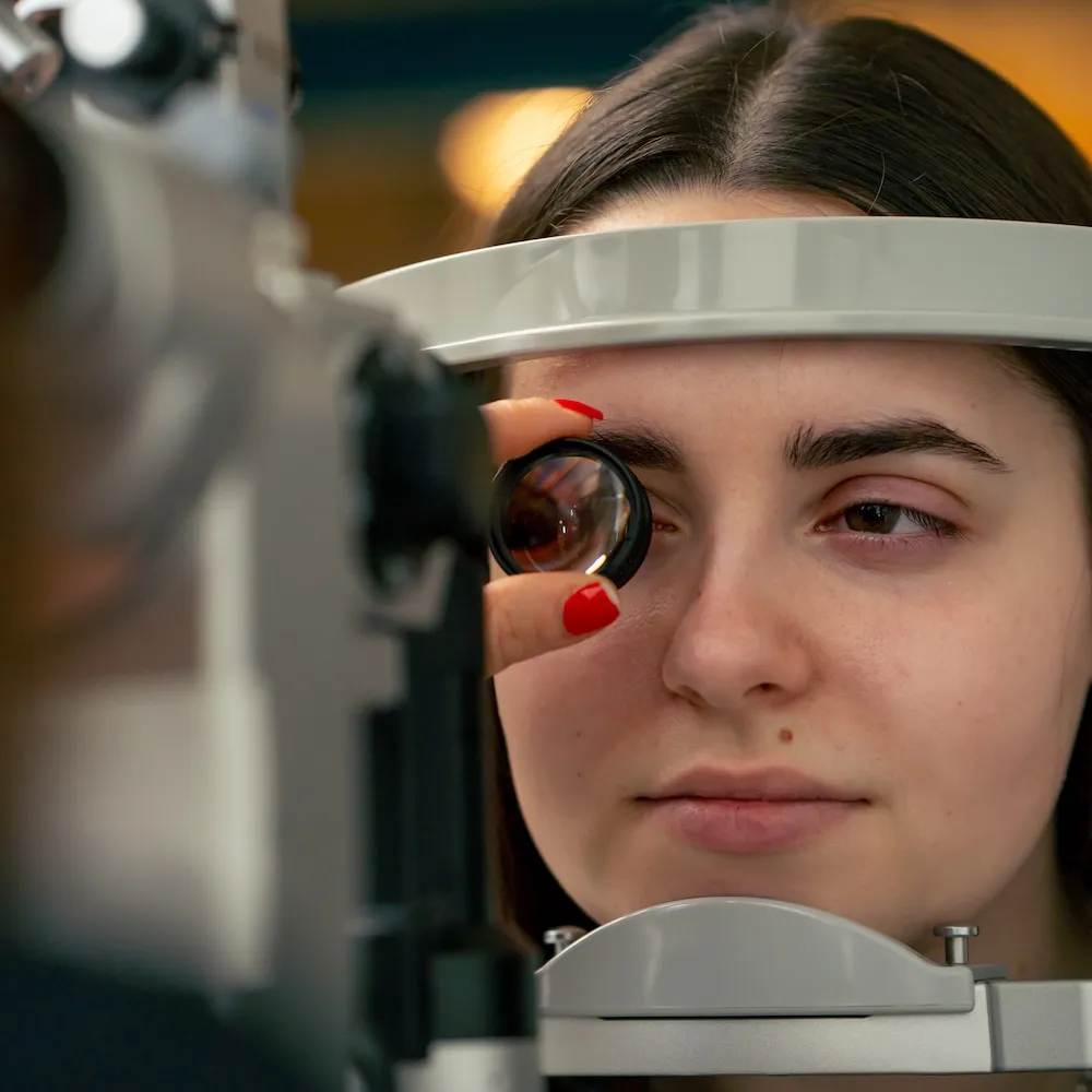 Patient receiving eye exam with professional medical equipment
