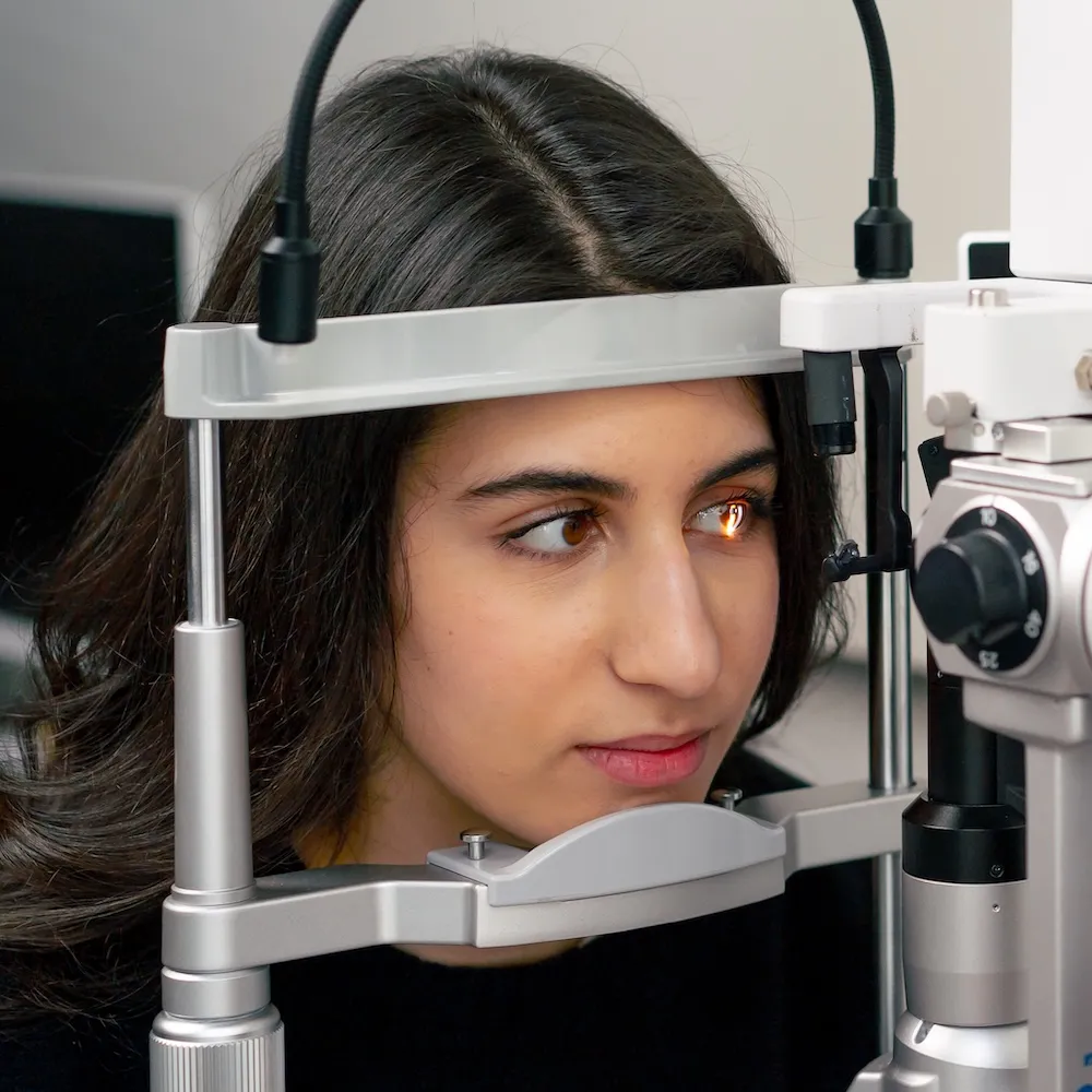 Patient undergoing eye examination with professional ophthalmic equipment