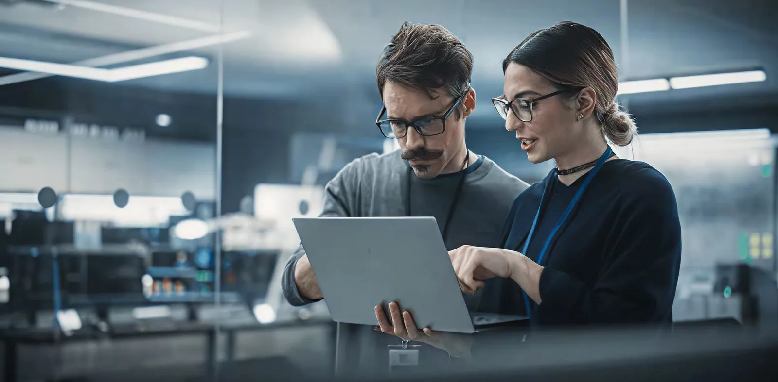 A man and a woman looking at a laptop