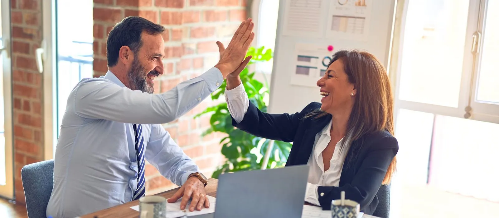 2 People high five each other