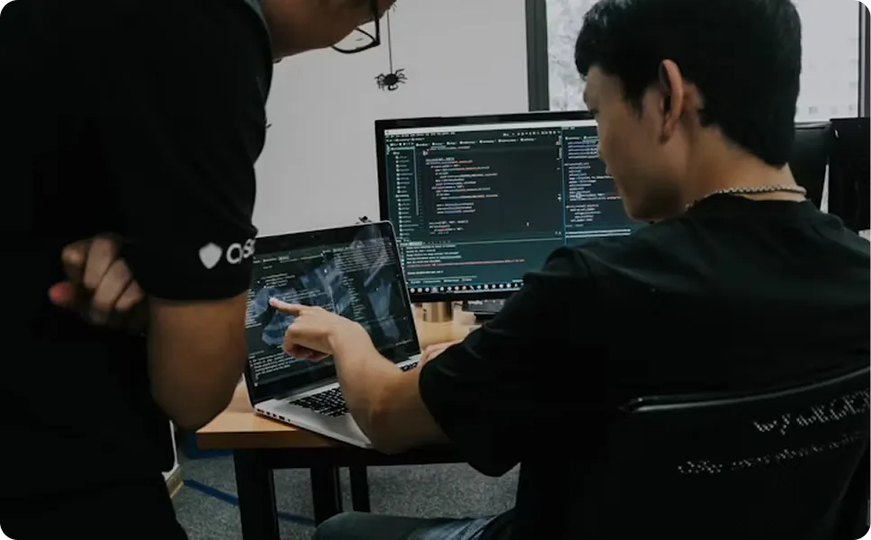 A man pointing at his laptop screen