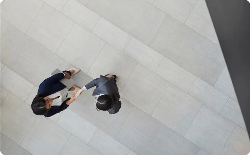 A top view of 2 people talking to each other