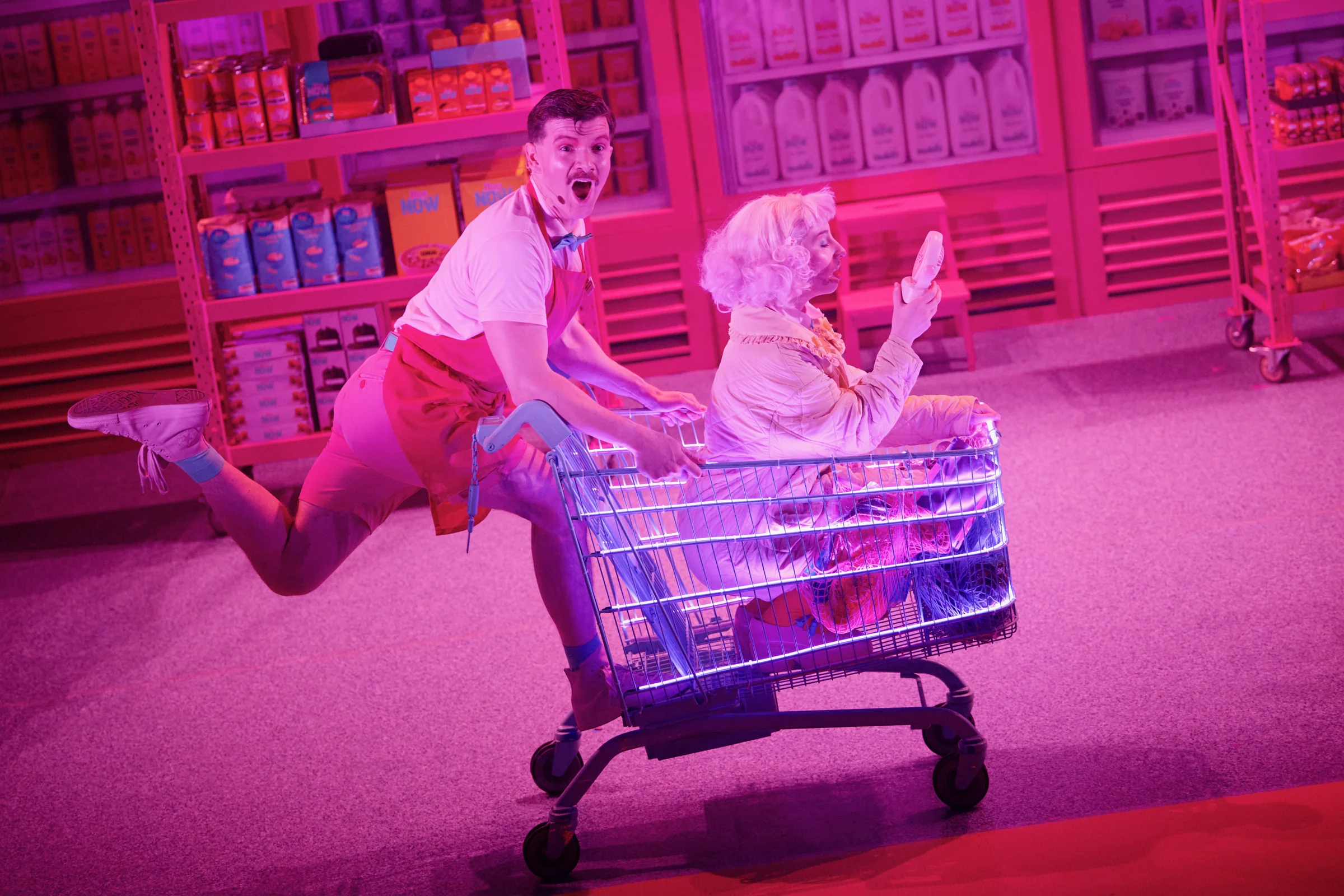 Andrew Gavin in a comic stage scene with a shopping trolley