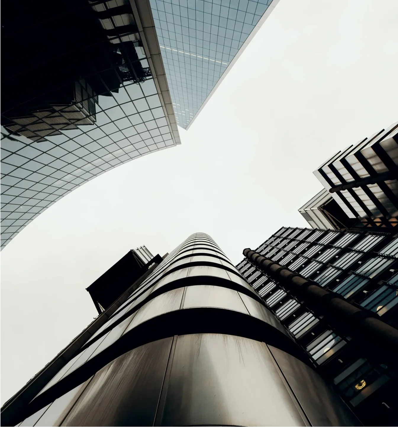 A view of the sky from the bottom of a building.
