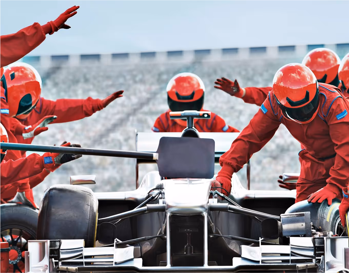 F1 pit crew around the car.