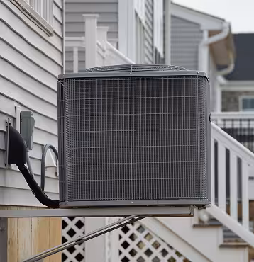 Air-source heat pump outdoor unit next to a house
